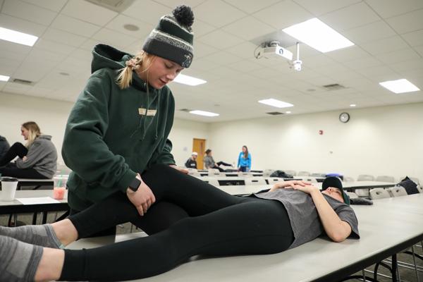 Student performing physical therapy on another person